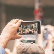 Person taking a picture of a performer.