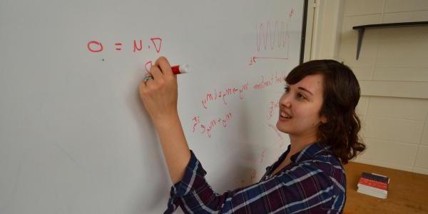 student doing problem on white board