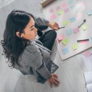 Photo of a person sitting down with sticky notes to set goals for the year.