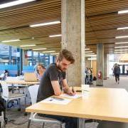 Photo of students studying for finals at tables in the engineering building.