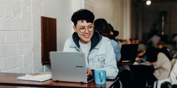 Student on laptop in cafe