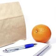 Brown bag with notepad and orange