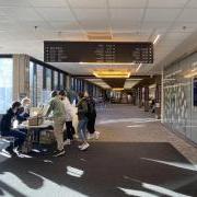 Campus community members gathering at a table in the engineering building lobby